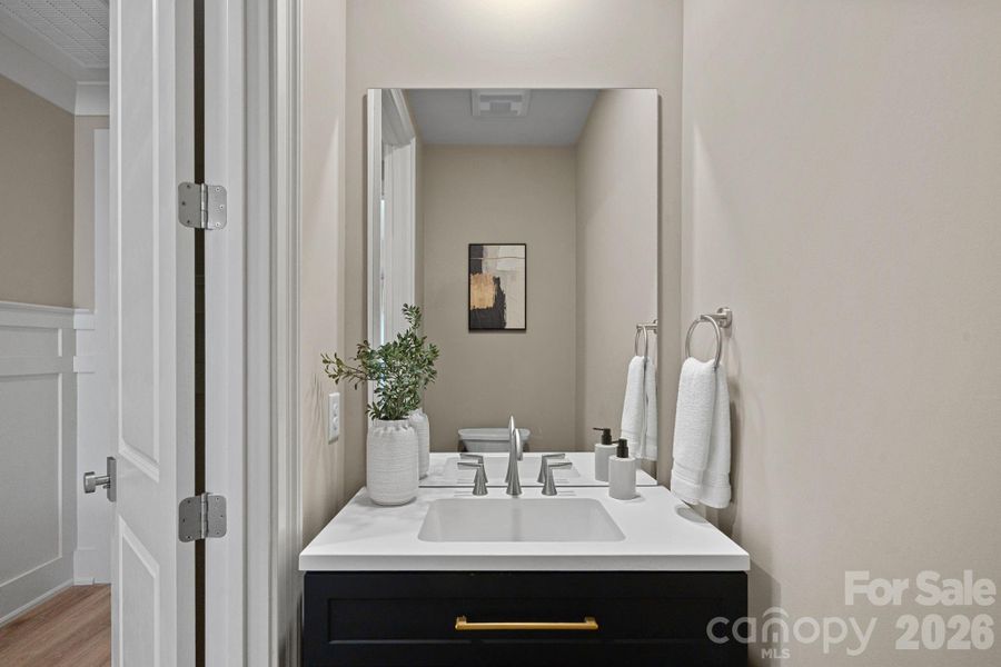 A beautifully appointed Powder Room just off the hallway, thoughtfully placed for guest convenience.