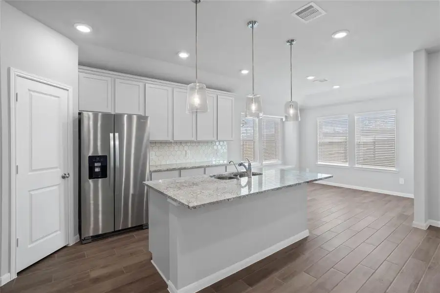 The kitchen island provides a convenient breakfast bar, perfect for casual dining and or long conversations.