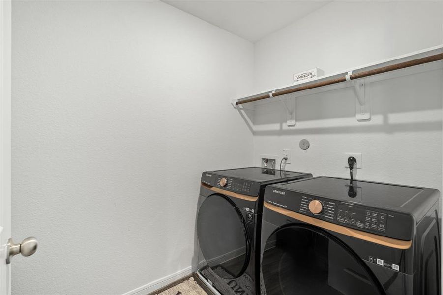 Incredible In-House Utility Room featuring fabulous flooring and enormous amounts of storage space to ensure your laundry day is a breeze!