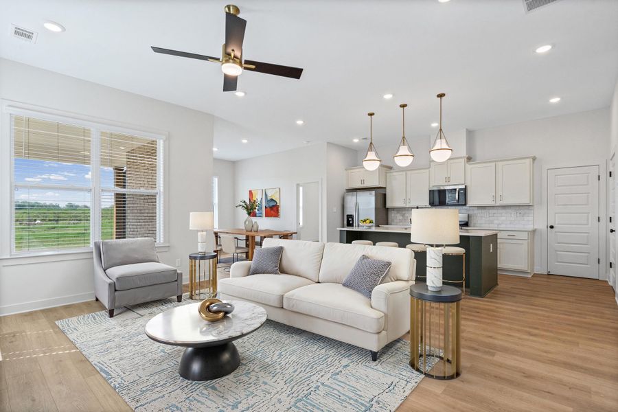 Living area featuring ceiling fan, light wood-style flooring, and recessed lighting