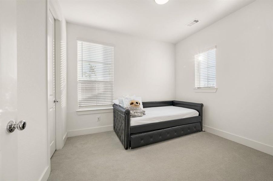 Carpeted bedroom featuring baseboards