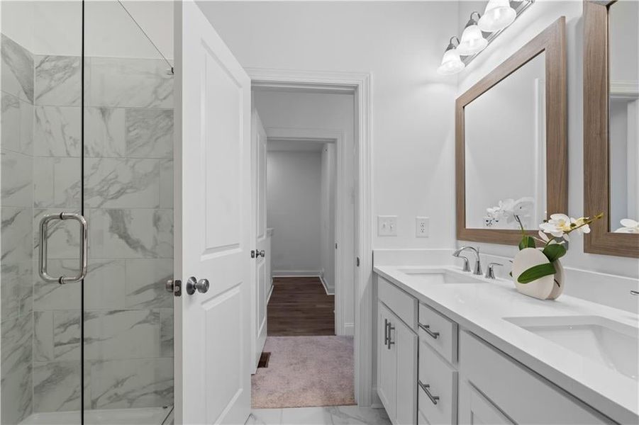 Owners Bath with frameless walk in shower & linen closet *Images shown are from a decorated model of the same floor plan. Design selections and color packages will vary by home.* Owners Bath with frameless walk in shower & linen closet *Images shown are from a decorated model of the same floor plan. Design selections and color packages will vary by home.*