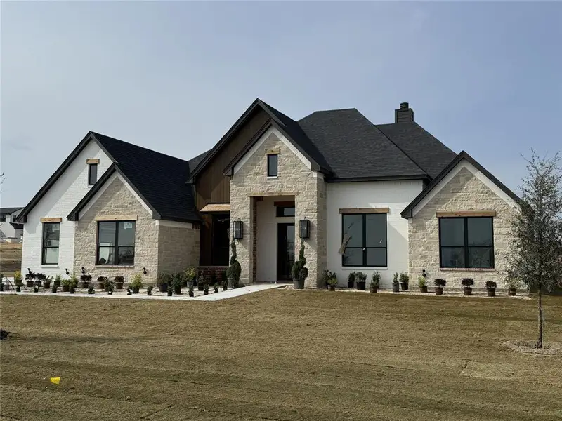 Front exterior of a new home in Summit Ranch, Aledo, TX, highlighting curb appeal (Image 1). Front exterior of a new home in Summit Ranch, Aledo, TX, highlighting curb appeal (Image 1).