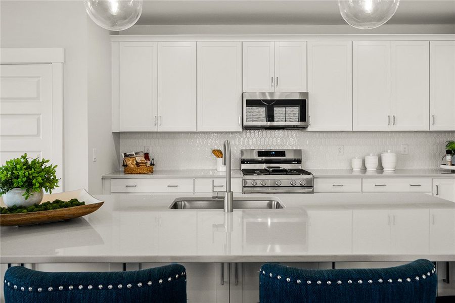A pristine culinary space features sleek stainless A pristine culinary space features sleek stainless