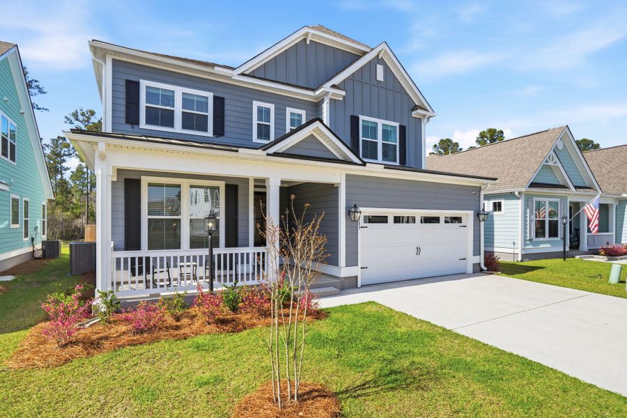 Front exterior of a new home in Tidewater at Lakes of Cane Bay, Summerville, SC, highlighting curb appeal (Image 26).