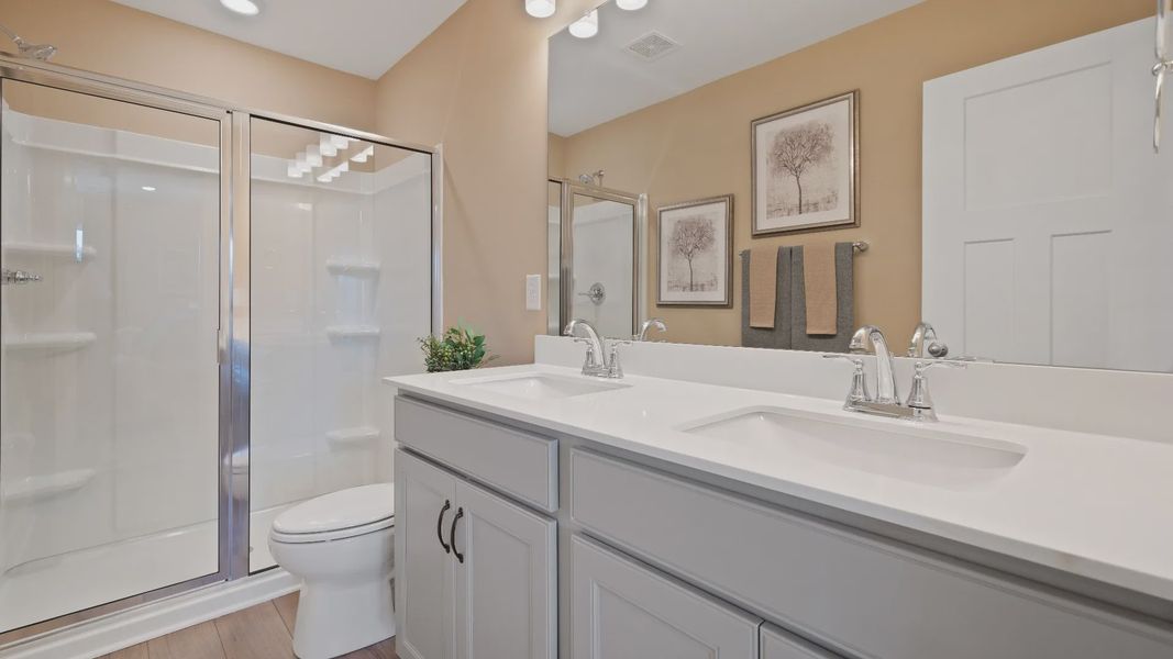 Notable primary suite with dual vanities and walk-in shower in this prime Anderson villa