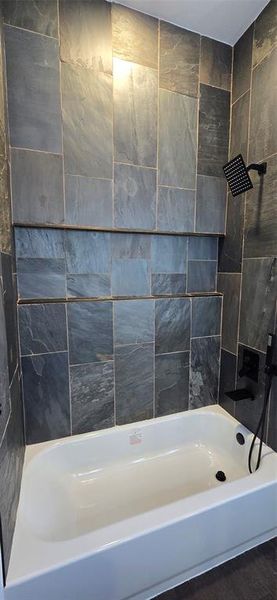 Bathroom featuring tub / shower combination with Grey stone Bathroom featuring tub / shower combination with Grey stone