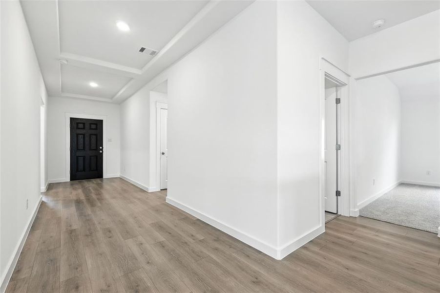 Foyer featuring light wood-style flooring and recessed lighting