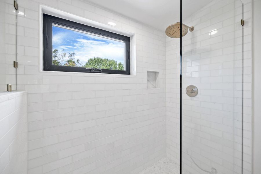 Full bathroom featuring tiled shower