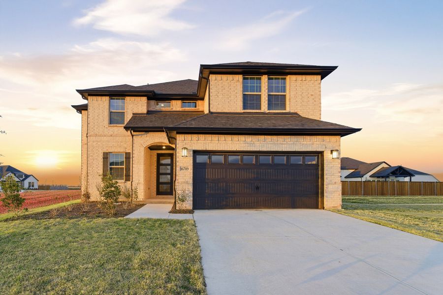 Front exterior of a new home in Green Meadows, Celina, TX, highlighting curb appeal (Image 1). Front exterior of a new home in Green Meadows, Celina, TX, highlighting curb appeal (Image 1).