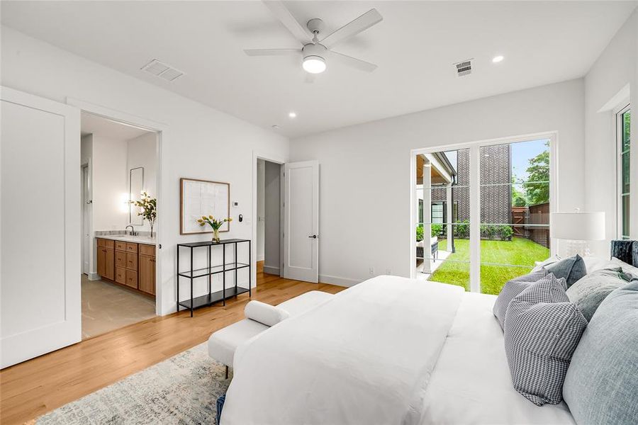 Bright interior with light wood-finish flooring, recessed lighting, and a ceiling fan