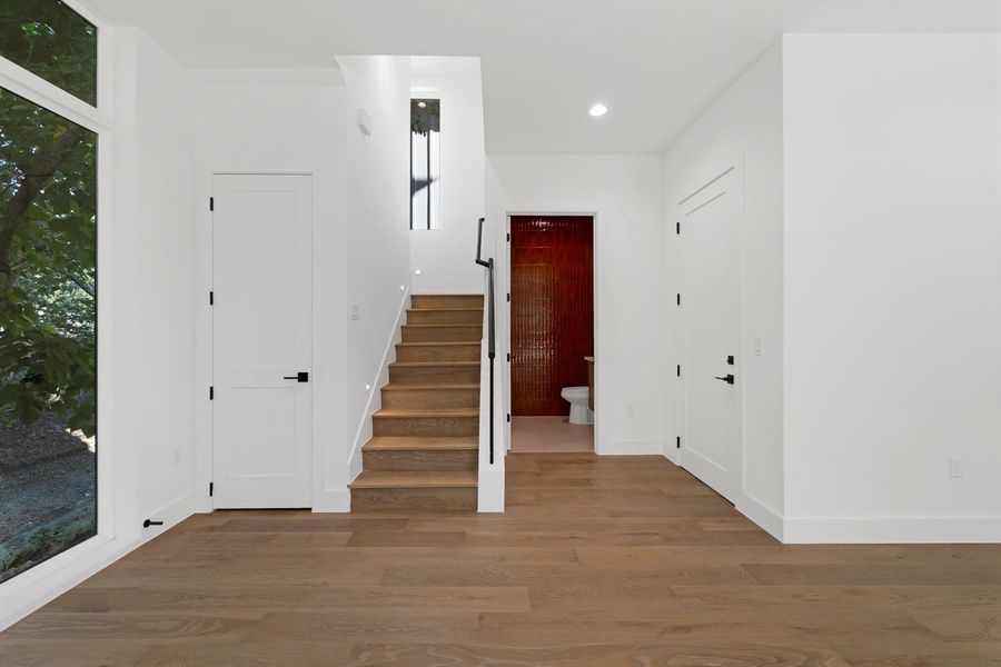 Foyer featuring wood finished floors, stairs, and recessed lighting Foyer featuring wood finished floors, stairs, and recessed lighting