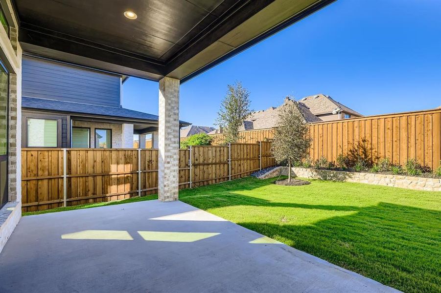 Fenced backyard with a patio area