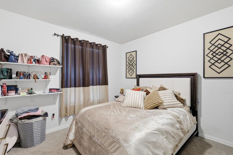 Bedroom featuring light carpet