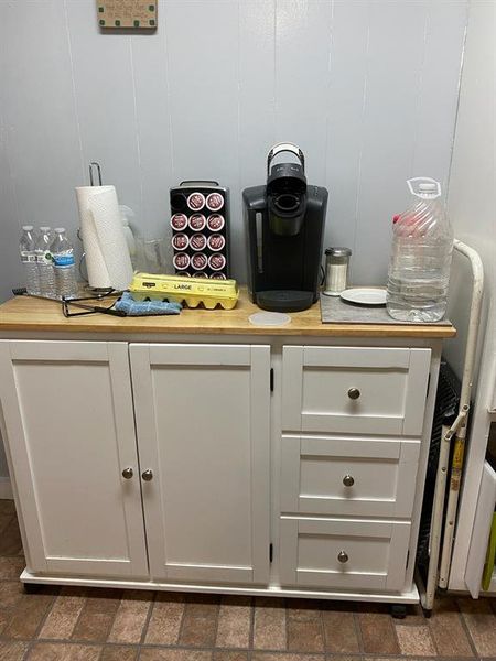 Bar with dark tile flooring and white cabinets Bar with dark tile flooring and white cabinets