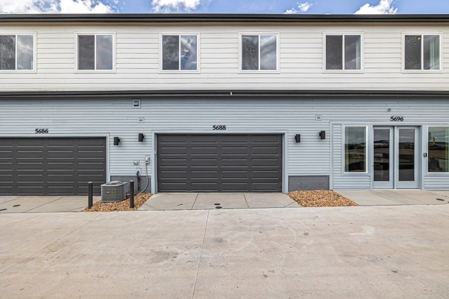 Front exterior of a new home in Painted Prairie, Aurora, CO, highlighting curb appeal (Image 28).