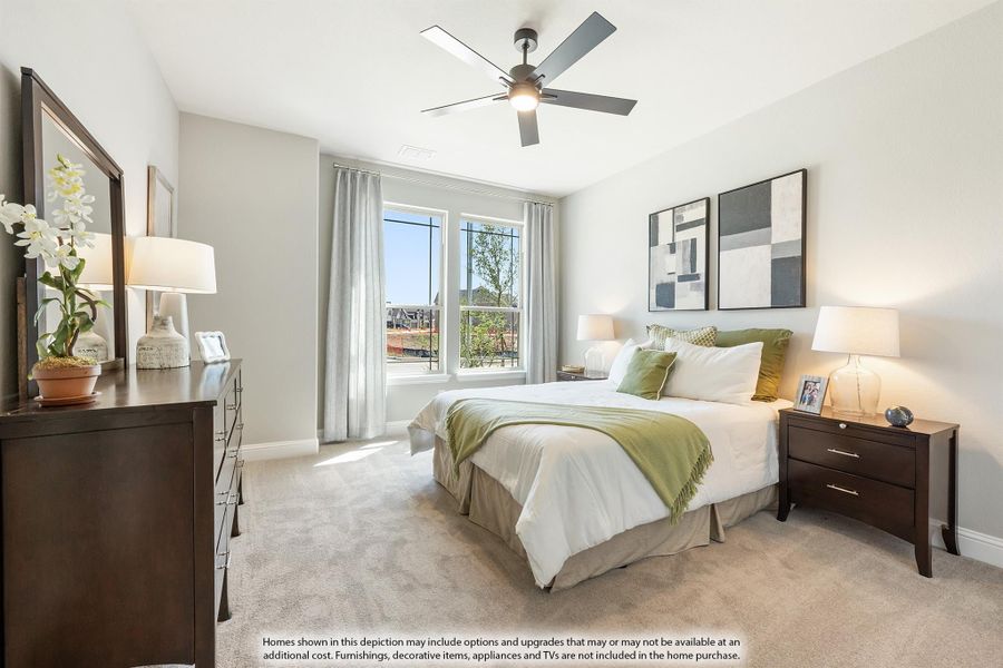 Bedroom with queen bed, ceiling fan, carpet floors, and large window with natural light