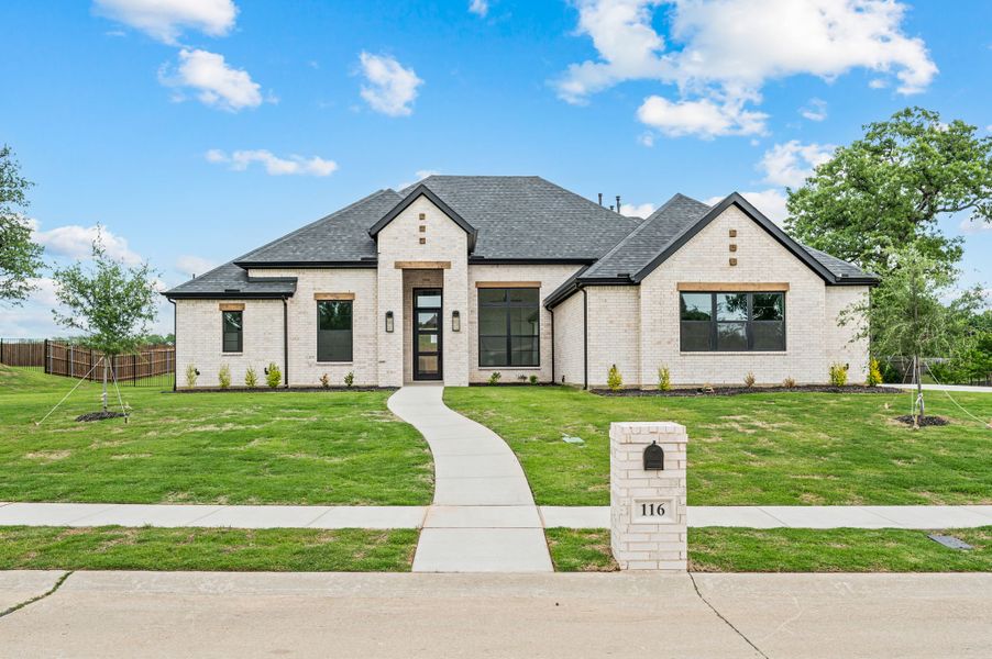 Front exterior of a new home in Highland Oaks, Boyd, TX, highlighting curb appeal (Image 1). Front exterior of a new home in Highland Oaks, Boyd, TX, highlighting curb appeal (Image 1).