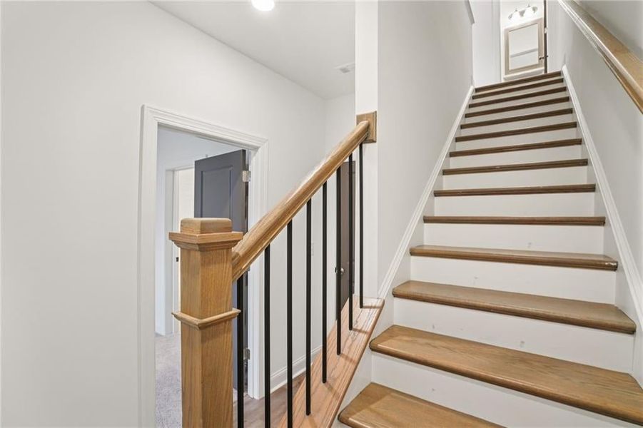Hardwood Stairs leading to bottom level  Pictures of not of actual home but same floorplan with similar options in same community* Townhome is complete