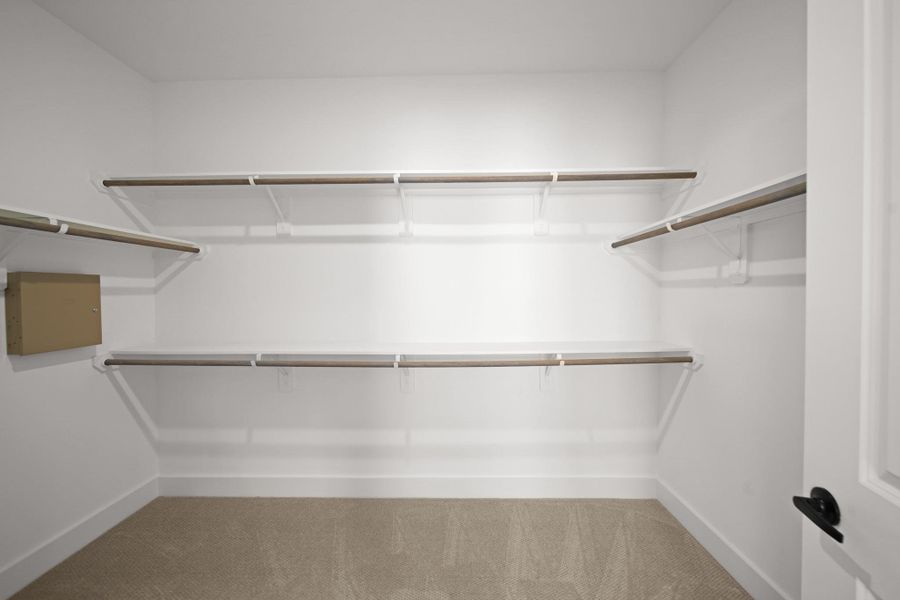 The walk-in closet offers generous space and plenty of storage, complete with open shelving, and two rows of hanging rods to accommodate a full wardrobe. The walk-in closet offers generous space and plenty of storage, complete with open shelving, and two rows of hanging rods to accommodate a full wardrobe.