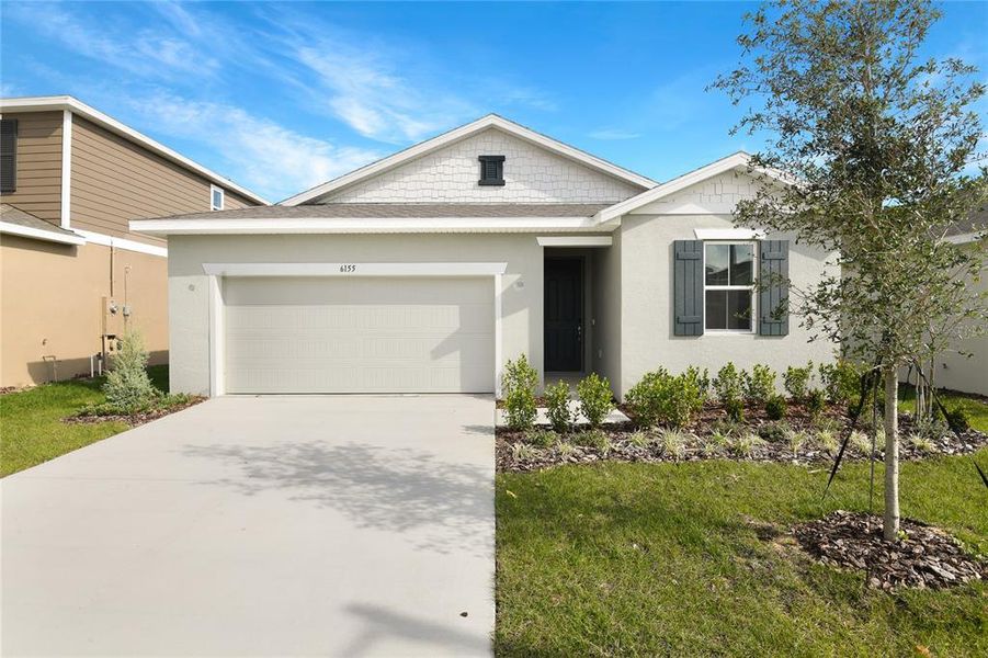 Front exterior of a new home in Seasons at Scenic Terrace, Lake Hamilton, FL, highlighting curb appeal (Image 2). Front exterior of a new home in Seasons at Scenic Terrace, Lake Hamilton, FL, highlighting curb appeal (Image 2).