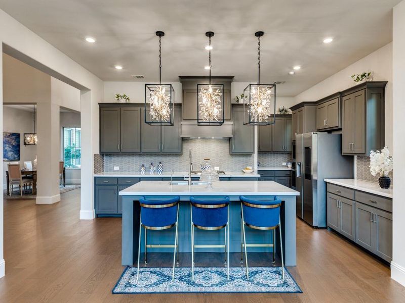 Kitchen with a chandelier, light countertops, wood finished floors, and recessed lighting