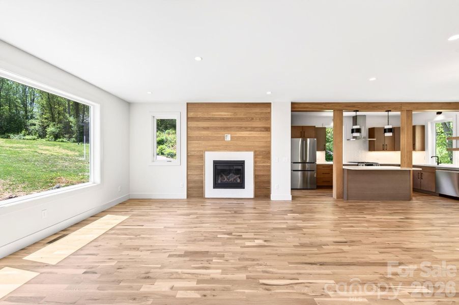 Bright Living Room with Shiplap and Tile-Surround Gas Fireplace