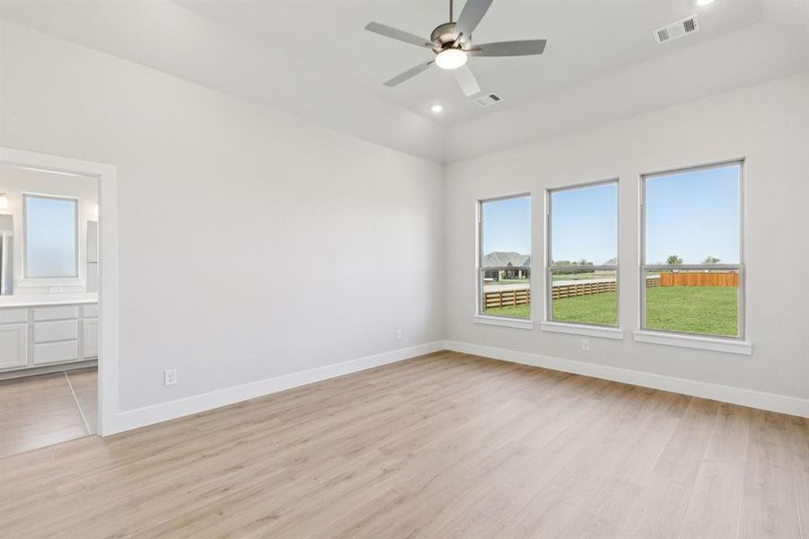 Empty room featuring light wood-style floors, recessed lighting, and a ceiling fan