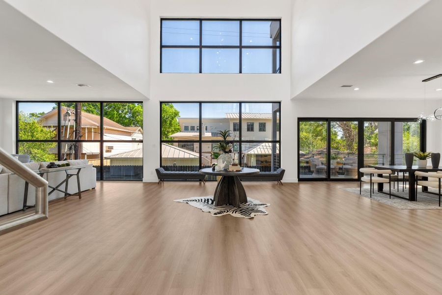 As you step inside, banks of floor to ceiling windows and sliding glass doors draw your eye and flood the space with natural light.