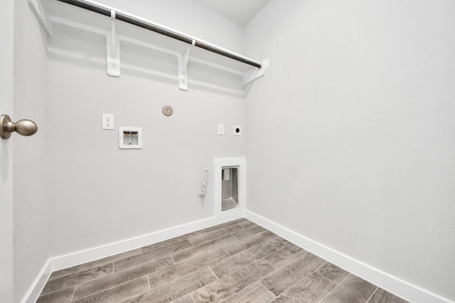 A perfect blend of functionality and comfort. Capture the essence of easy living with a first-floor laundry room, thoughtfully equipped with shelving for effortless organization. Both electric and gas connections available.