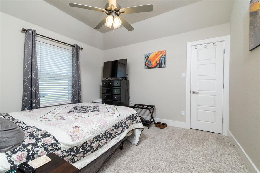 Bedroom featuring light colored carpet and ceiling fan