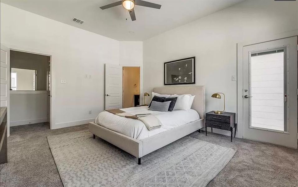 Carpeted bedroom featuring ceiling fan