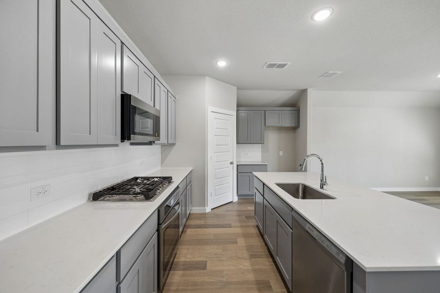 Kitchen in the Emmy II home plan by Trophy Signature Homes - REPRESENTATIVE PHOTO