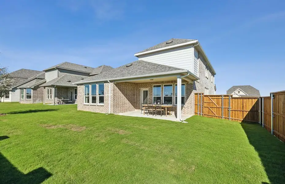 Spacious, fenced-in backyard with covered patio *model representation