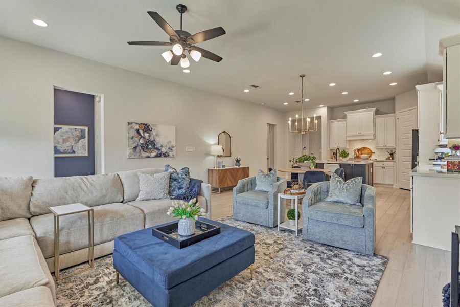 Open floor plan.  Large comfortable den area with 3 large picture windows with motorized shades over looking private backyard.