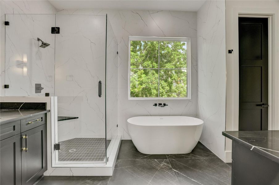 The primary bathroom offers a spa-like retreat with dual vanities, walk-in shower, and separate soaking tub. The primary bathroom offers a spa-like retreat with dual vanities, walk-in shower, and separate soaking tub.