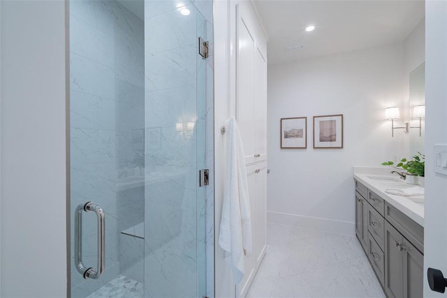 Bathroom featuring walk in shower and vanity