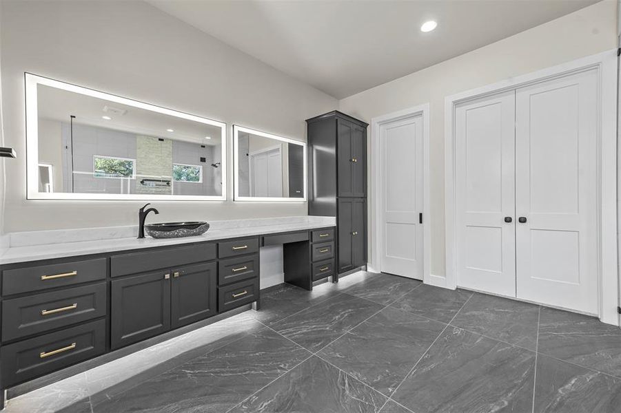 Separate quartz vanities, LED mirrors to illuminate your smile, & motion-activated toe kick lighting adding to the allure of convenience