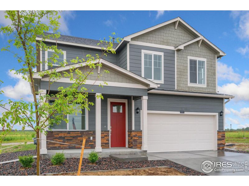 Front exterior of a new home in Silver Peaks, Lochbuie, CO, highlighting curb appeal (Image 2).