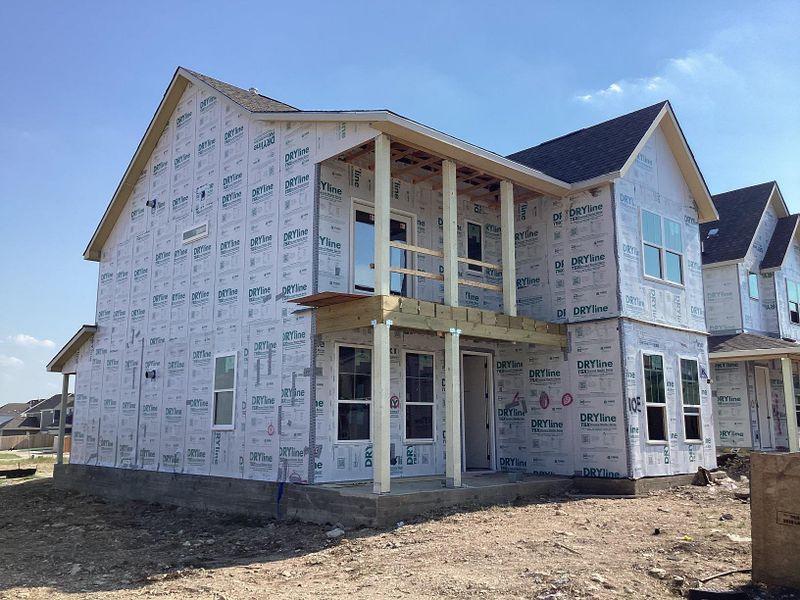 Front exterior of a new home in The Cottages at Lariat, Liberty Hill, TX, highlighting curb appeal (Image 14). Front exterior of a new home in The Cottages at Lariat, Liberty Hill, TX, highlighting curb appeal (Image 14).