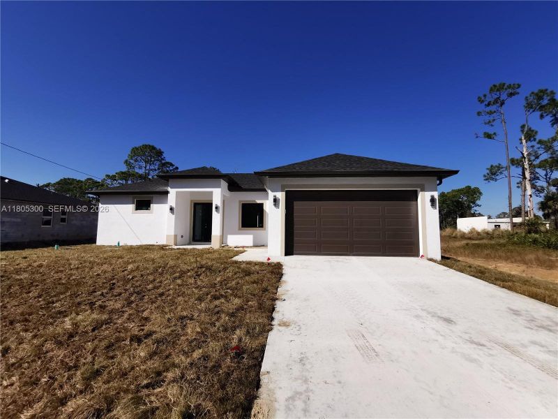 Front exterior of a new home in , Lehigh Acres, FL, highlighting curb appeal (Image 20).