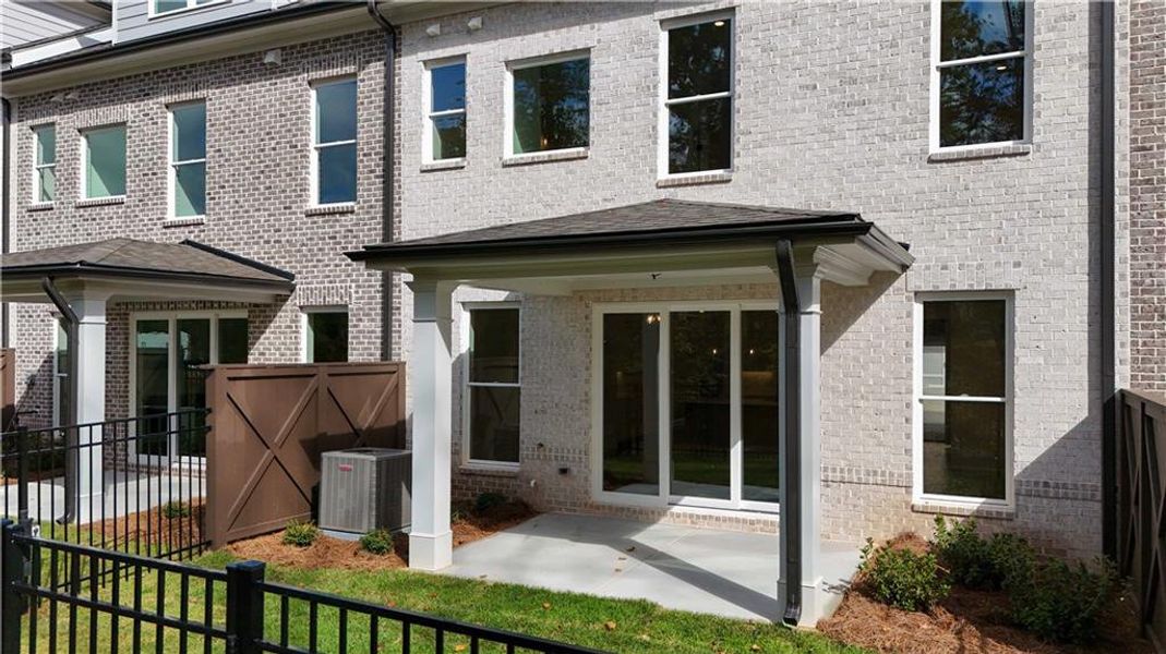 Exterior details and patio area of a home in Ward's Crossing Townhomes, Johns Creek (Image 3).