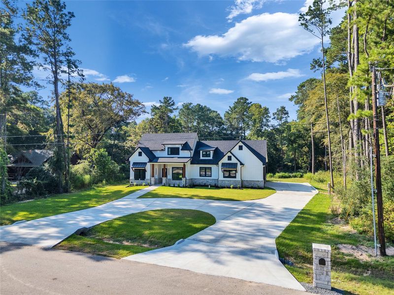 Front exterior of a new home in , Magnolia, TX, highlighting curb appeal (Image 27).
