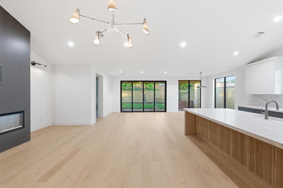 The expansive open-concept layout seamlessly connects the living, dining, and kitchen areas—perfect for both everyday living and entertaining.