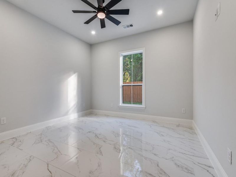 2nd room with light marble finish flooring, ceiling fan, and recessed lighting.
