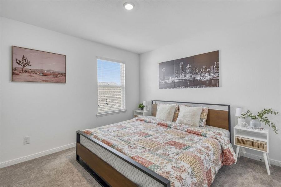 Carpeted room with a single window, white walls, and recessed lighting Carpeted room with a single window, white walls, and recessed lighting