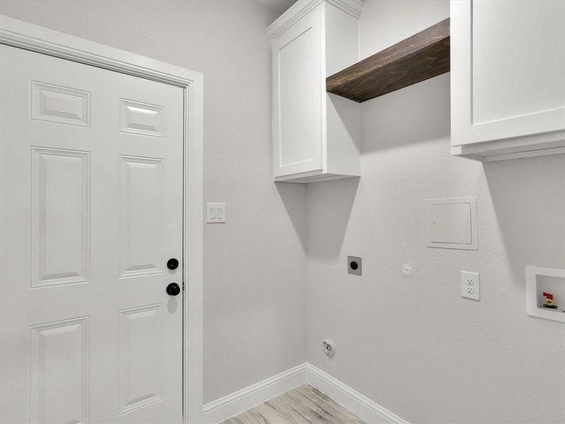 Washroom featuring electric dryer hookup, cabinets, gas dryer hookup, and hookup for a washing machine