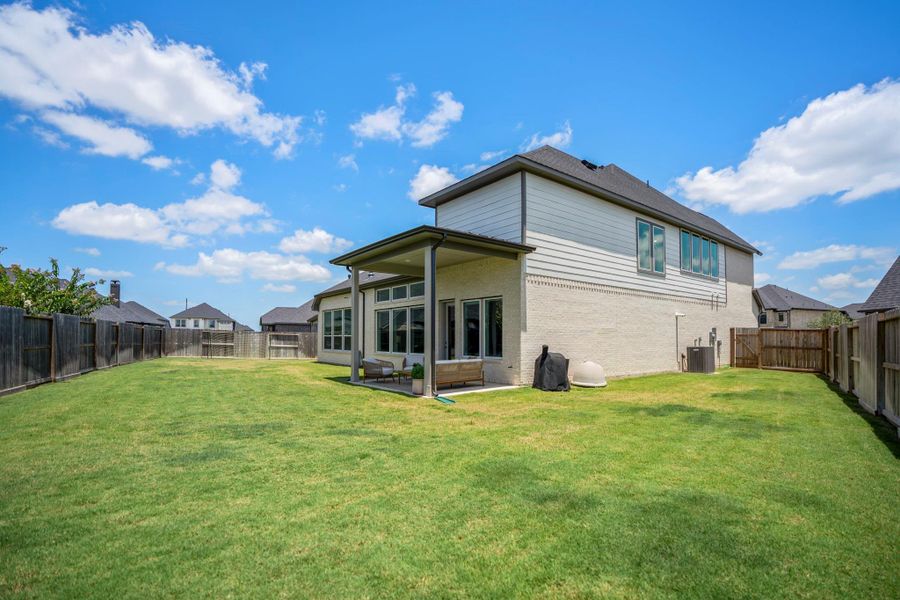 This expansive fenced backyard offers plenty of room to play, garden, entertain or add a future pool, while the covered patio and full sprinkler system make outdoor living and lawn care easy.