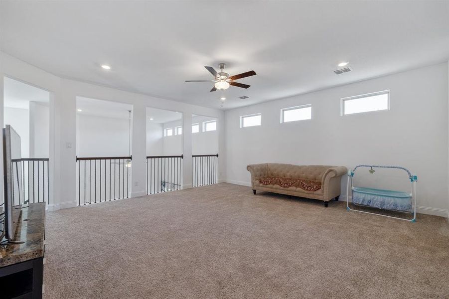 Living area with a healthy amount of sunlight, carpet floors, and recessed lighting