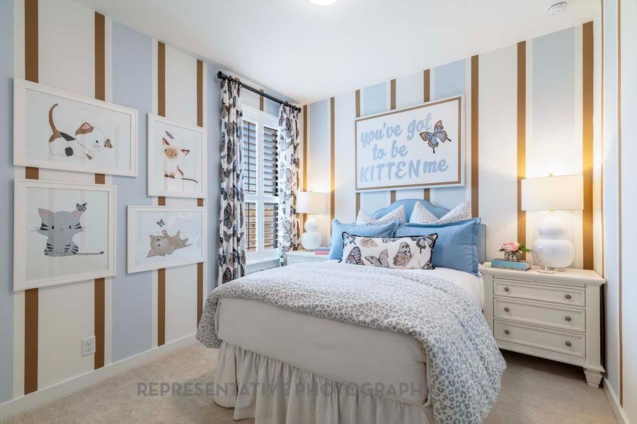 Bedroom with wallpapered walls and light colored carpet Bedroom with wallpapered walls and light colored carpet